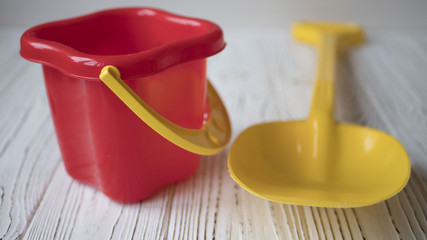 Children bucket and shovel on table