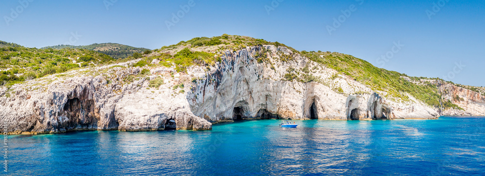 Obraz na płótnie Blue caves at the cliff of Zakynthos island with small boat, Greece w salonie