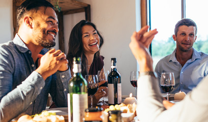 Group of friends enjoying meal together at home