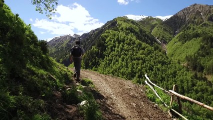 Wall Mural - young man with a backpack hiking in the mountains of geogia.