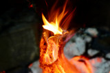 Fototapeta Miasto - Fire in the fireplace, tongues of flame from a burning log on fire