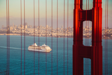 Wall Mural - Golden Gate Bridge with cruise ship at sunset, San Francisco, California, USA