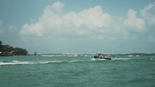 Slow Motion Long Shot Of Two Pilothouse Recreational Trawler Boats Filled With Tourists Crossing The Johor Strait From Singapore To The Island Of Pulau Ubin
