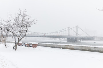 Wall Mural - Heavy snowfall in Moscow. Snow-covered roads and Krymsky Bridge. Collapse of public services