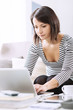 © StockPhotoPro - Woman using a laptop at home