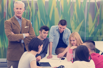 Wall Mural - portrait of  teacher with students group in background