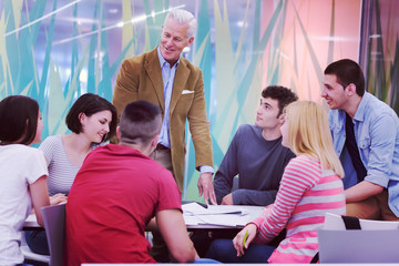 Wall Mural - teacher with a group of students in classroom