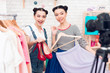 © freeograph - Two fashion blogger girls present colorful dress and red shoes to camera.