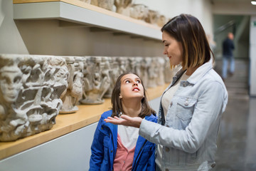 Poster - Mother and daughter regarding classical bas-reliefs