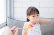 © gamelover - Little asian girl close her mouth by hand refuse to eat tomato in spaghetti