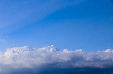 Spring. blue sky with fluffy white clouds. sun, sunlight, clouds, sky - spring changeable weather.