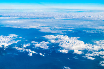 Wall Mural - blue sky and cloud top view from airplane window,nature background