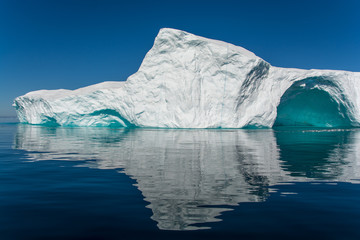 Wall Mural - reflection of iceberg. big wall with arch and still water.
