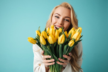 Portrait of a laughing young blonde woman in sweater