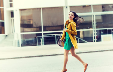 Poster - fashion and people concept - happy young woman or teenage girl running on city street