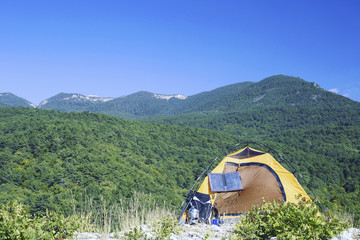 Wall Mural - The tent is on top of the mountain. The solar panel hangs on the tent.