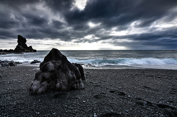 Amazing rock formations made by erstwhile flowing lava on a black sand beach in Iceland