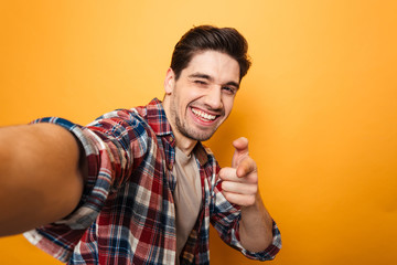 Canvas Print - Portrait of a cheerful young man taking a selfie