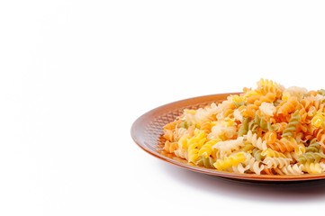 Food and drink concept - uncooked pasta on palte isolated on white background. Top view.