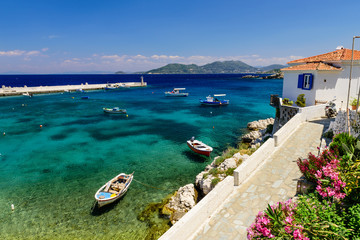 Wall Mural - the picturesque village of Kokkari with traditional houses and fishing boats. Kokkari village is a popular tourist place on the island of Samos, Greece