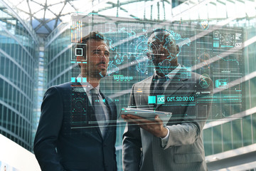 Two business man in suits, use a futuristic latest advanced holographic technology. Concept of: future, technology, smartphone, augmented reality