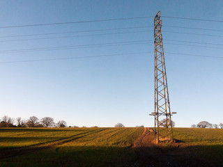 Wall Mural - large metal tower field farm blue sky electric pylon communication power supply background