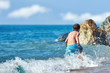 © Artem - Cute Caucasian boy is running in the water along the sea shore.