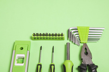 Mix of different tools on green background