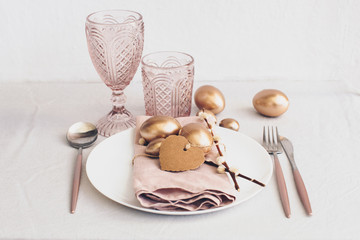 Easter Table setting in rustic background. Rose tones