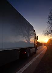 Truck transportation on the road at sunset