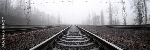 Cuadros en Lienzo The railway track in a misty morning