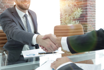 financial partners handshake after signing contract