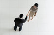 © Prasit Rodphan - Top view of Asian businessman and businesswoman shaking hands in office lobby. Welcome to business..