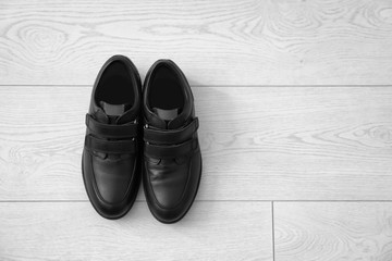 Sticker - Casual male shoes on wooden floor