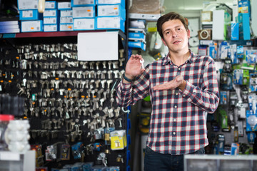 Wall Mural - worker in hardware store trading goods and keys in uniform