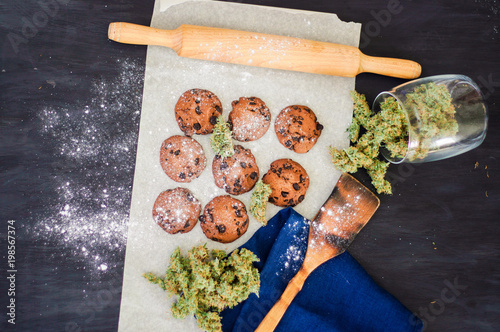 Cuadros en Lienzo Cookies with cannabis and buds of marijuana on the table