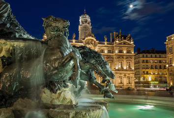 Renovated Fontain Bartholdi and Hotel de Ville de Lyon at Place des Terreaux in the evening.