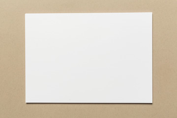 Canvas Print - White business card on wooden table. Blank portrait A4.