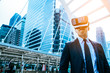 A young man in virtual reality glasses makes business and meeting in the city. Future technology concept.