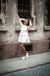 © Елена Кравчук - Young woman standing on ancient street, city, old textured wall