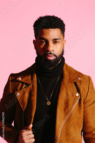 Fotografie, Obraz Simple portrait of a cool African American man with beard, isolated on pink stud