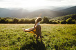 © Eastlyn Bright - Woman wearing long dress spinning in a field in the summer sun