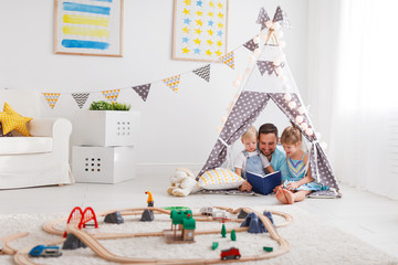 Sticker - family father reading to children book in tent at home