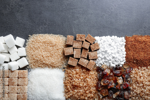 Fotografía Flat lay composition with different types of sugar on gray background