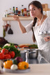 © lenets_tan - Cooking woman in kitchen with wooden spoon