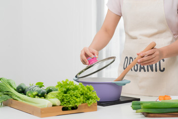 Wall Mural - Young Woman Cooking in the kitchen. Healthy Food. Dieting Concept. Healthy Lifestyle. Cooking At Home. Prepare Food