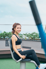 Wall Mural - Asian woman exercising at outdoors gym playground equipment