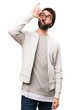 © luismolinero - Hipster man making drunk gesture on white background