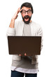 © luismolinero - Surprised Hipster man with laptop on white background