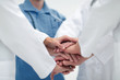 © ASDF - closeup.Small group of doctor team joining hands,
